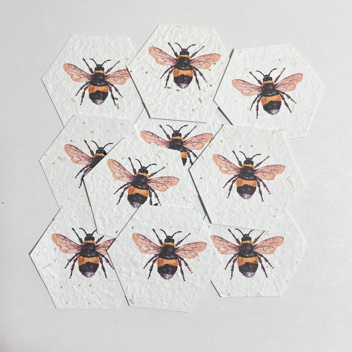 seed paper hexagons with printed bees